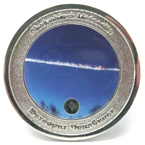 This is a picture of a limited edition coin which commemorates the Chelyabinsk impact. The coin also contains a small piece of that meteorite.